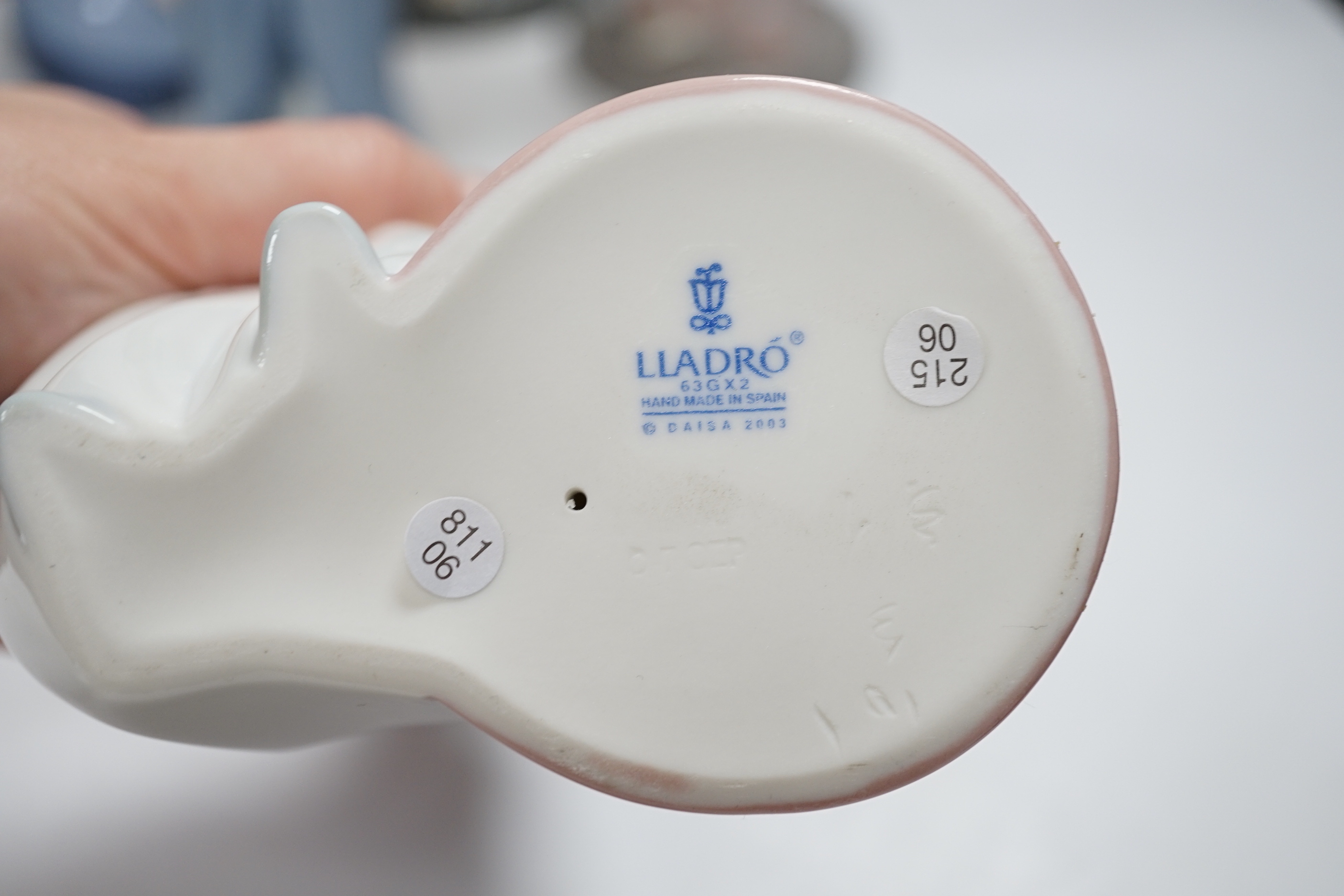 A collection of twelve Lladro figures and a Lladro plaque